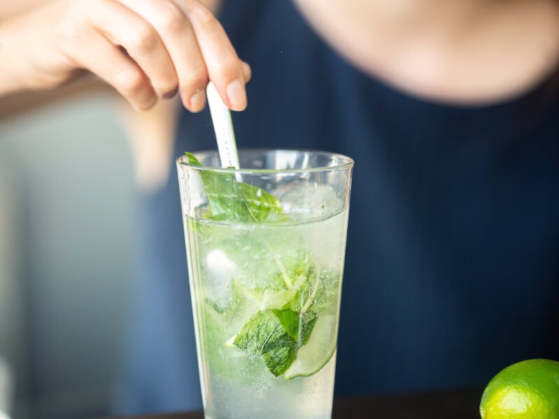 woman stirring cocktail at home